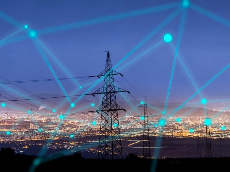 Image d'une centrale électrique avec un ciel nocturne superposé à des connecteurs numériques représentant la cybersécurité pour les infrastructures critiques.